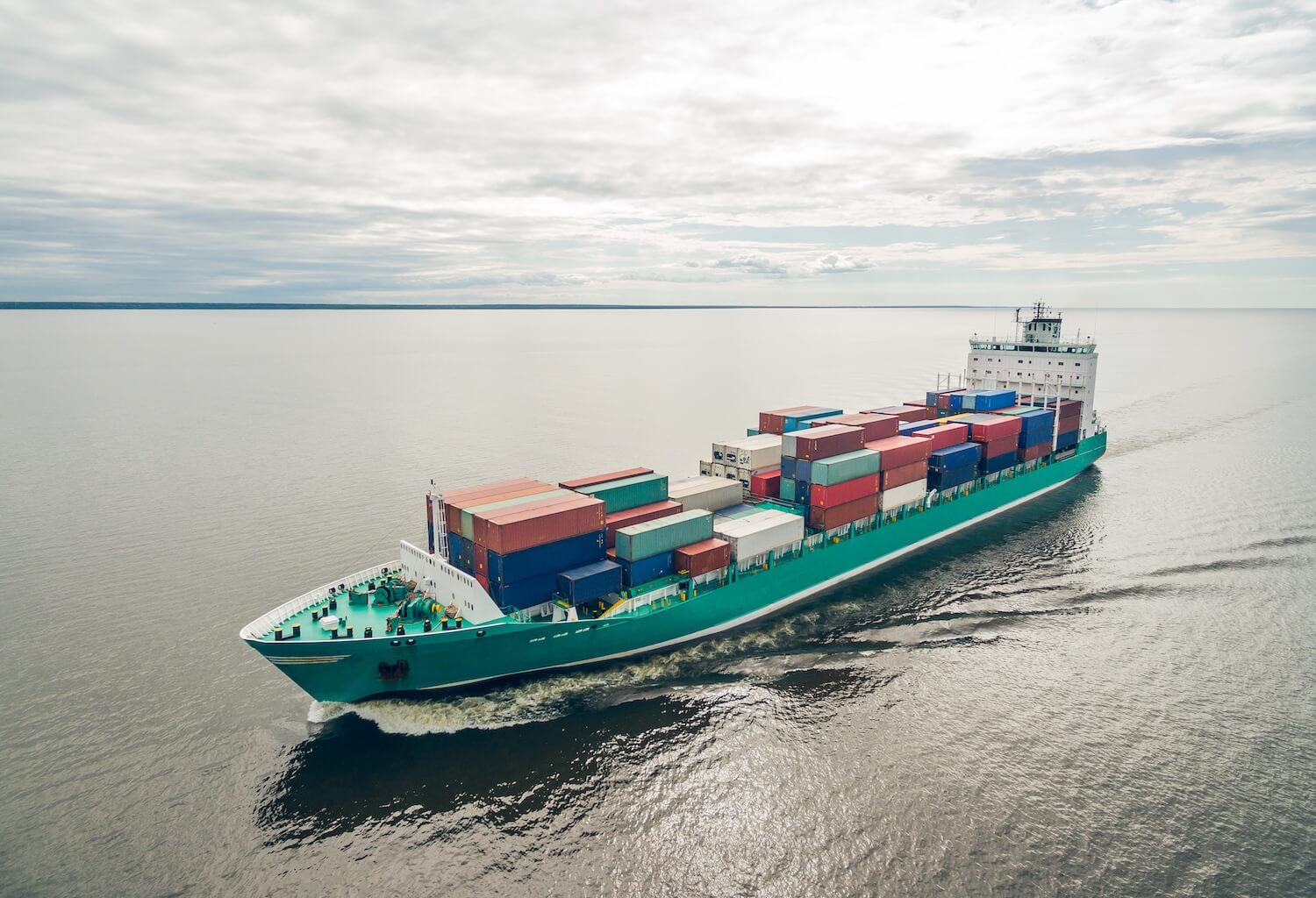 Boat sailing at sea illustrating international vehicle shipping routes
