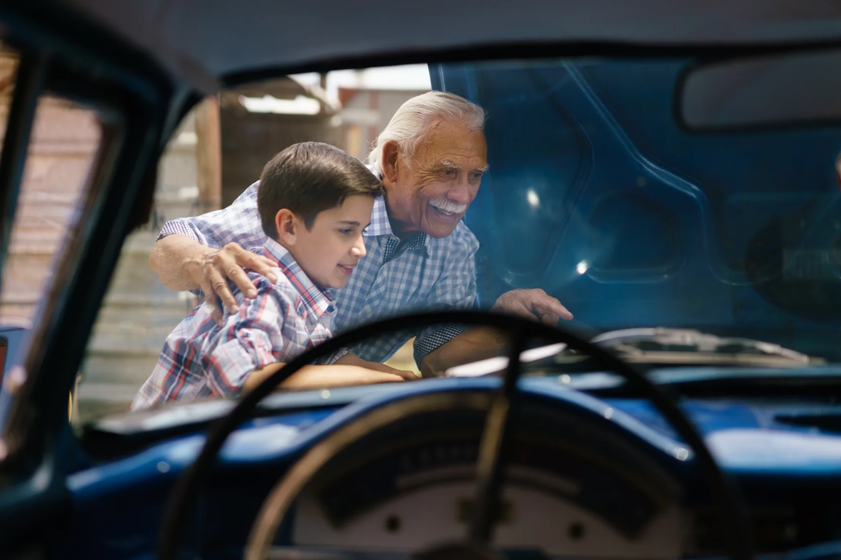 Family inspecting a car engine before international car shipping